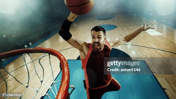 full length portrait of a basketball player with ball - slam dunk stock pictures, royalty-free photos & images