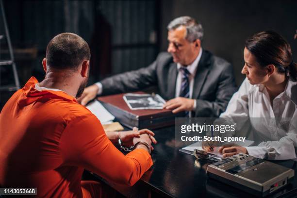 police and prisoner in interrogation room - probation stock pictures, royalty-free photos & images