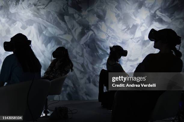 People watch a virtual reality movie during a show organized for the Beijing International Film Festival on April 16, 2019 in Beijing, China. The...