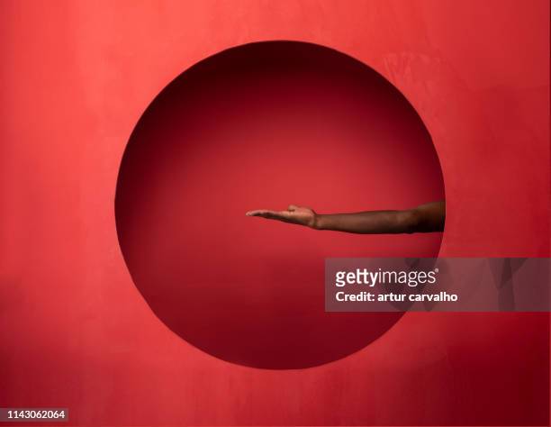 arm and hand on set red background - hands circle fotografías e imágenes de stock