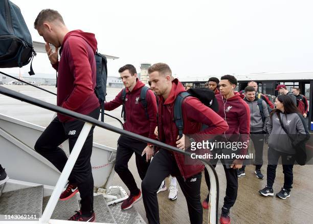 Andy Robertson and Jordan Henderson of Liverpool boarding the plane at John Lennon Airport on April 16, 2019 in Liverpool, England.