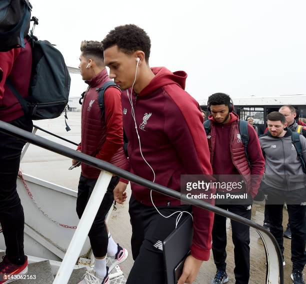Roberto Firmino and Trent Alexander-Arnold of Liverpool boarding the plane at John Lennon Airport on April 16, 2019 in Liverpool, England.