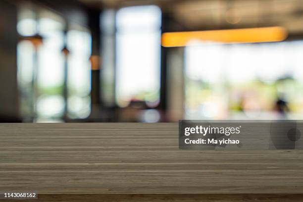 empty wooden table space platform and blurred shopping mall - inside coffe store stock pictures, royalty-free photos & images