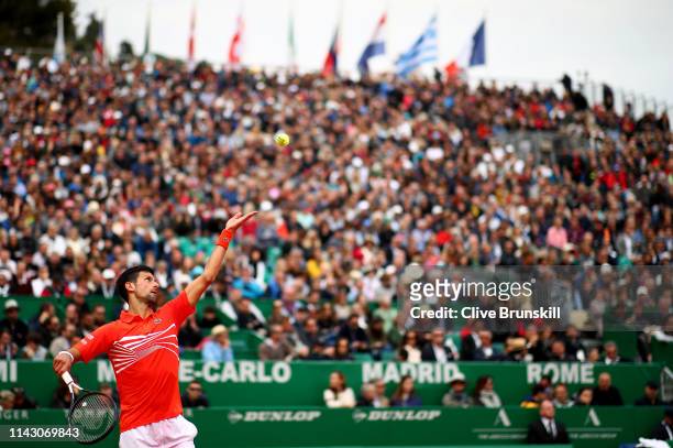 Novak Djokovic of Serbia serves against Philipp Kohlschreiber of Germany in their second round match during day 3 of the Rolex Monte-Carlo Masters at...