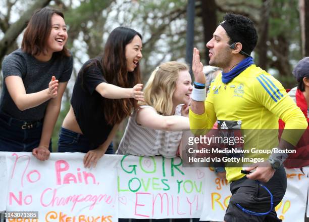 Akram Shalabi blows kisses to spectators outside Wellesley College as he runs in the Boston Marathon on April 15, 2019 in Wellesley, Massachusetts.