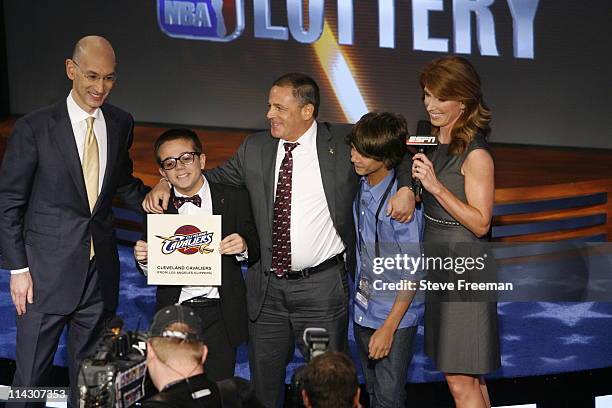 Deputy Commissioner Adam Silver, Nick, Dan and Grant Gilbert, Heather Cox of ESPN pose for a picture after the Cavaliers won the number one overall...