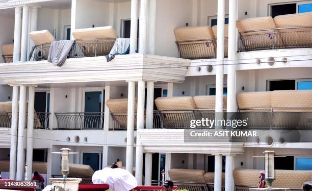 Mattresses of a hotel dry on balconies in Puri in the eastern Indian state of Odisha on May 10, 2019 after the passage of cyclone "Fani". - At least...