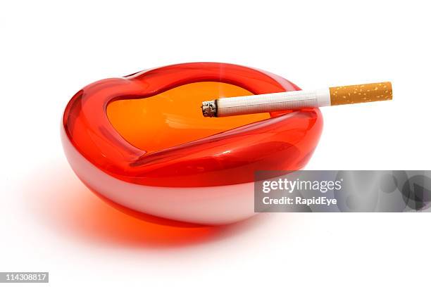 retro red and white ashtray with lit cigarette - ashtray stock pictures, royalty-free photos & images
