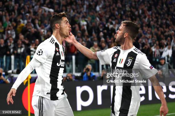 Cristiano Ronaldo of Juventus celebrates after scoring his team's first goal with Miralem Pjanic of Juventus during the UEFA Champions League Quarter...