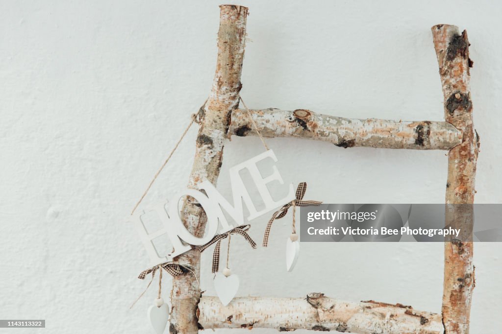 Decorative home letter hanging on the stairs
