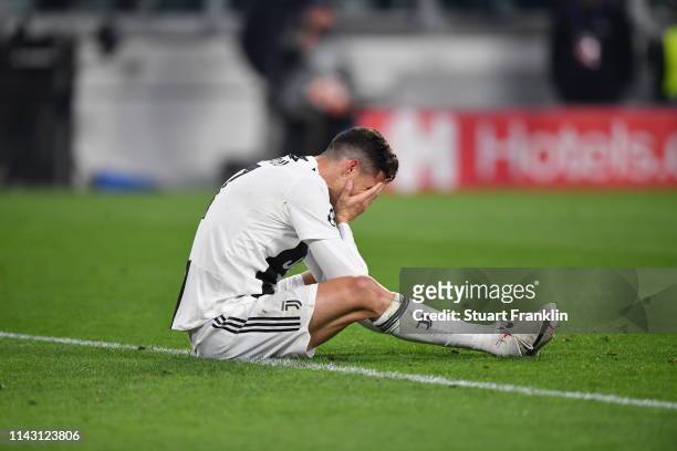 Christiano Ronaldo of Juventus sits with his head in the hands during the UEFA Champions League Quarter Final second leg match between Juventus and...