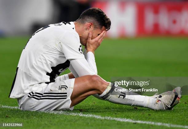 Christiano Ronaldo of Juventus sits with his head in the hands during the UEFA Champions League Quarter Final second leg match between Juventus and...