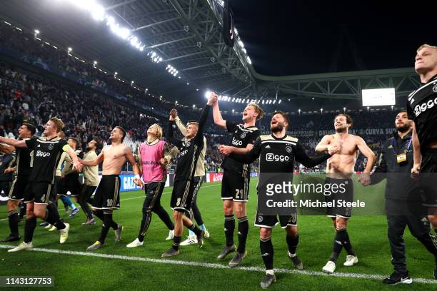 The Ajax team celebrate victory after the UEFA Champions League Quarter Final second leg match between Juventus and Ajax at Allianz Stadium on April...