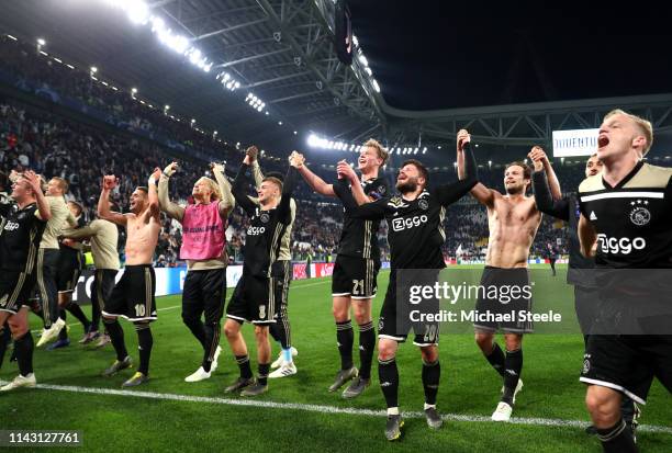 The Ajax team celebrate victory after the UEFA Champions League Quarter Final second leg match between Juventus and Ajax at Allianz Stadium on April...