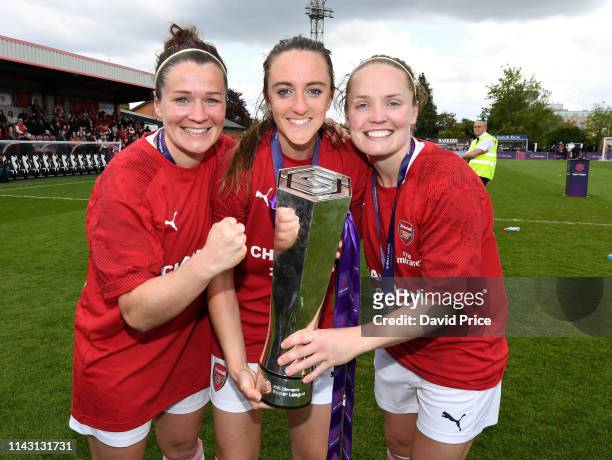 Emma Mitchell, Lisa Evans and Kim Little of Arsenal with the WSL Trophy after the match between Arsenal Women and Manchester City Women at Meadow...
