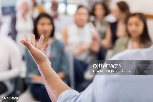 an unidentified speaker explains his point - press conference stock pictures, royalty-free photos & images