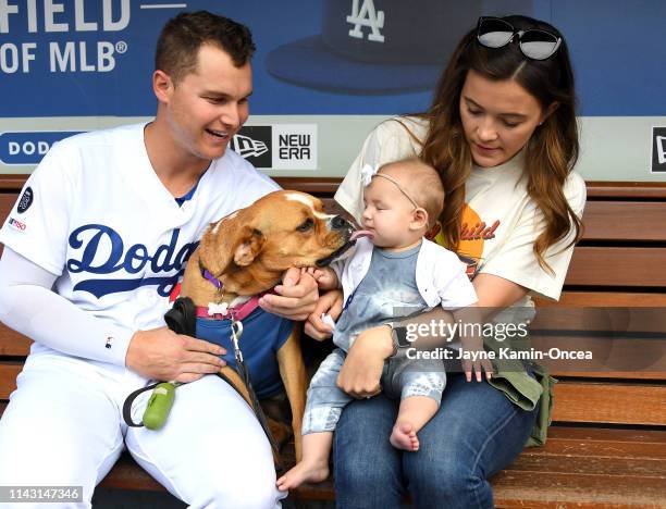 Joc Pederson of the Los Angeles Dodgers poses with his wife Kelsey, dog Blue and daughter Poppy as more than 700 dogs attend the game between the Los...