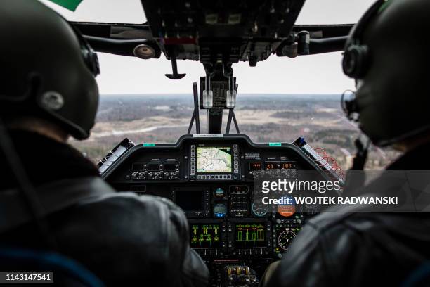 Latvian border guard pilots from Ludze station are seen during a helicopter flight over the Latvian-Russian border near Zilupe, eastern Latvia, on...