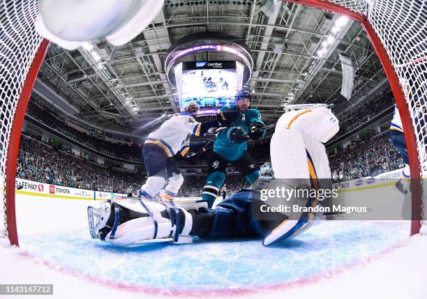 Logan Couture of the San Jose Sharks battles in front of the net after Joe Pavelski's goal against Jordan Binnington of the St. Louis Blues in Game...