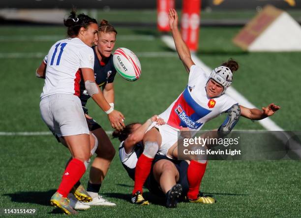 Camille Grassineau of France drops the ball while being tackled by Kristi Kirshe of the USA during the HSBC World Rugby Sevens Series at Westhills...