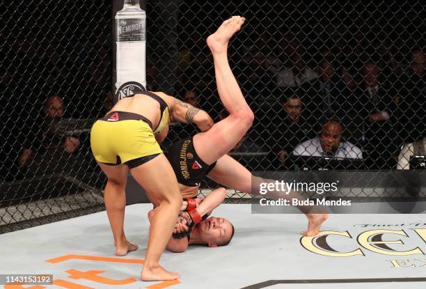 Jessica Andrade of Brazil slams Rose Namajunas, knocking her out, in their women's strawweight championship bout during the UFC 237 event at Jeunesse...