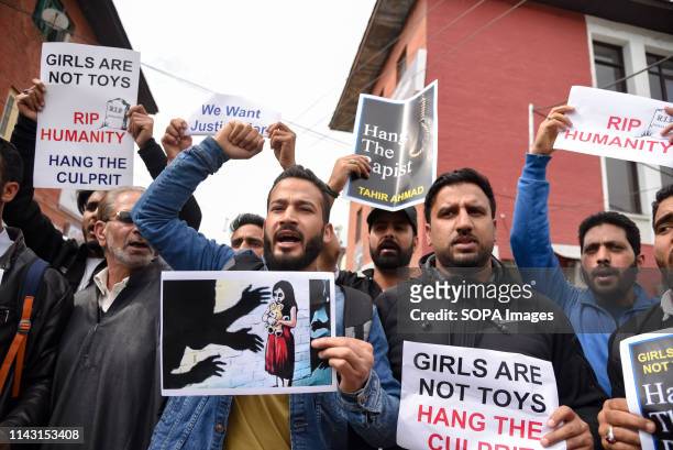 Kashmiri youths seen shouting slogans while holding placards during a Protest against the rape of a three year old girl. A three year old girl was...