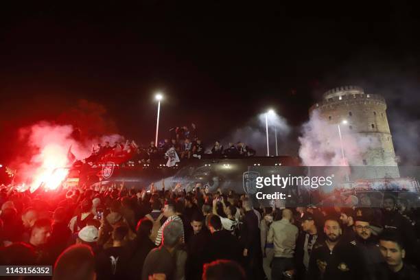 Paok FC fans celebrate after winning the Greek Cup final football match against AEK Athens in front of the White Tower in Thessaloniki on May 12,...