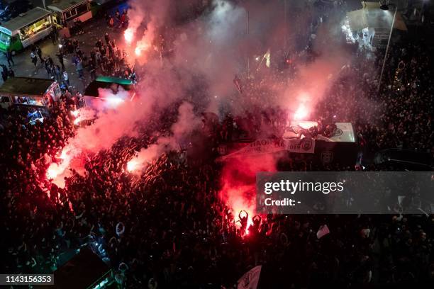 Paok FC fans burn flares as they celebrate after winning the Greek Cup final football match against AEK Athens in Thessaloniki on May 12, 2019. -...