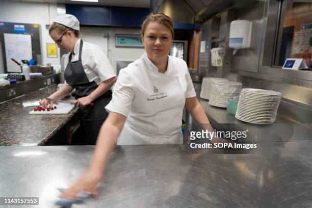 Sarah Frankland seen cleaning her working surface in the kitchen at the Pennyhill Park hotel where she is the head pastry chef during the Show. Sarah...