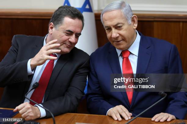 Israeli Prime Minister Benjamin Netanyahu listens to Transportation Minister Yisrael Katz at the start of the weekly cabinet meeting at his Jerusalem...