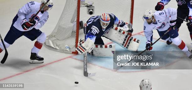 United States' goalkeeper Thatcher Demko vies for the puck with France's forward Tim Bozon and France's forward Damien Fleury during the IIHF Men's...