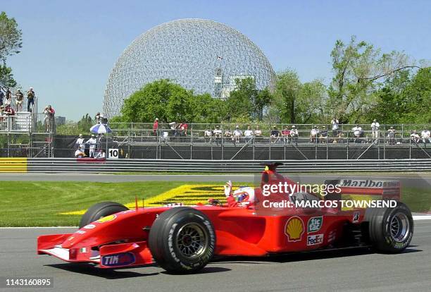 Ferrari's Rubens Barrichello from Brazil acknowledges the crowd's cheers as he passes the Biodome negotiating the hairpin turn during practice 08...