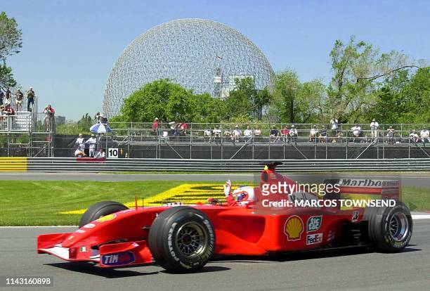 Ferrari's Rubens Barrichello from Brazil acknowledges the crowd's cheers as he passes the Biodome negotiating the hairpin turn during practice 08...