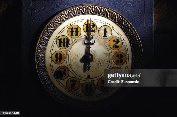 vintage clock striking 12 - 午夜 個照片及圖片檔