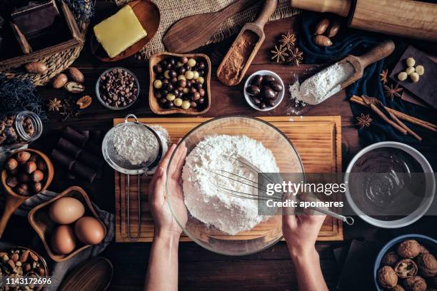 woman hands making chocolate mousse and cookies on a wooden table in a rustic kitchen - texture mousse stock pictures, royalty-free photos & images