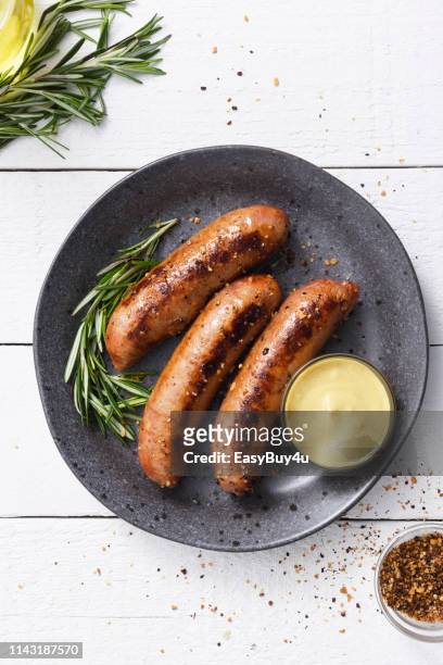 sausages with dijon mustard sauce and seasoning - sausage stock pictures, royalty-free photos & images