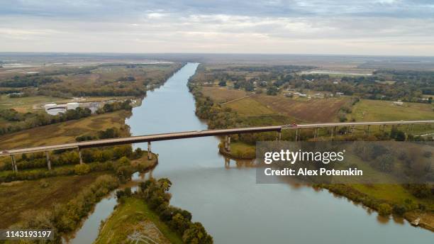 the highway and bridge across the vermillion river nearby abbeville, louisiana, in autumn. - vermillion stock pictures, royalty-free photos & images