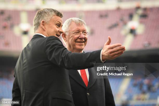 Sir Alex Ferguson speaks to Ole Gunnar Solskjaer, Manager of Manchester United on the pitch prior to the UEFA Champions League Quarter Final second...