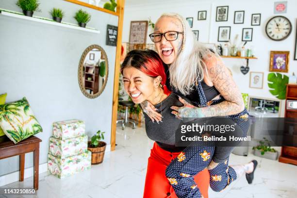 stong, independent, artistic, business women who design and create tattoos from their bright and unique shop - showus business stock pictures, royalty-free photos & images