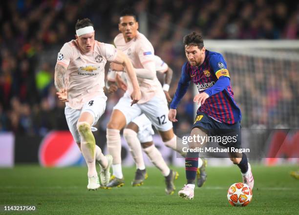 Lionel Messi of Barcelona in action with Chris Smalling and Phil Jones of Manchester United during the UEFA Champions League Quarter Final second leg...