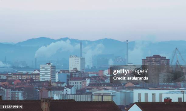 cityscape of gijón with pollution at sunrise - gijón fotografías e imágenes de stock