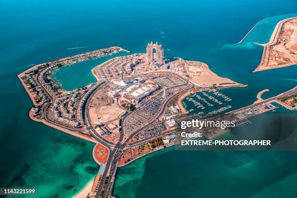 helicopter view of a marina in abu dhabi, united arab emirates - emirates palace stock pictures, royalty-free photos & images