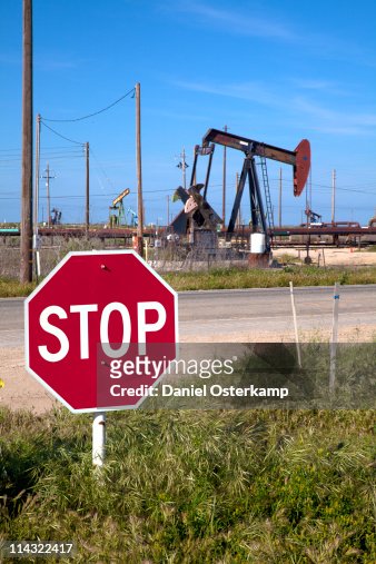 Oil field with stop sign and drilling