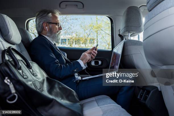 classy dressed businessman working in car - different car models stock pictures, royalty-free photos & images