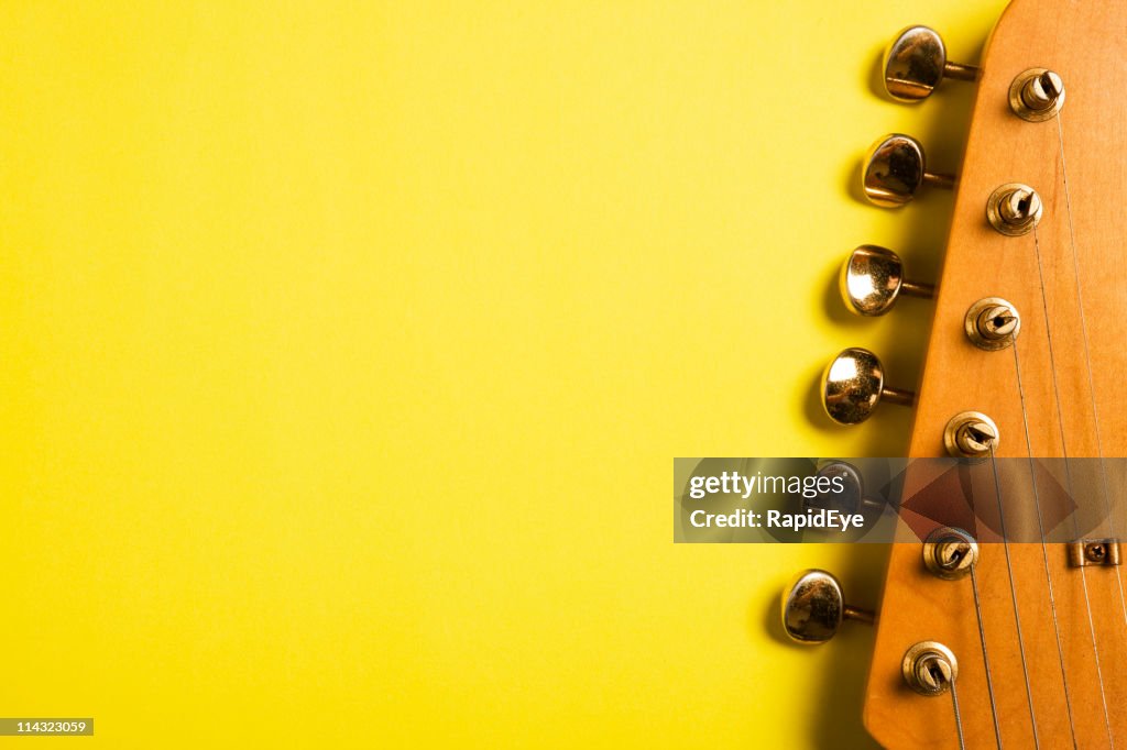 Guitar headstock on yellow