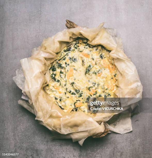 filo pastry pie preparation - spinach pie stock pictures, royalty-free photos & images