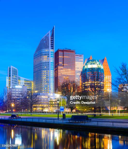 downtown business district of the hague at night, the netherlands - the hague stock pictures, royalty-free photos & images