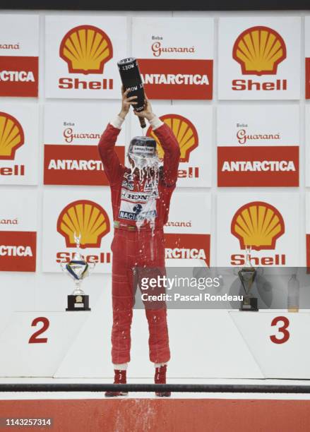 Ayrton Senna of Brazil and driver of the Honda Marlboro McLaren MP4-6 Honda pours Moet et Chandon champagne over himself as he celebrates winning the...