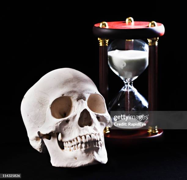 human skull and hourglass - souvenir stock pictures, royalty-free photos & images