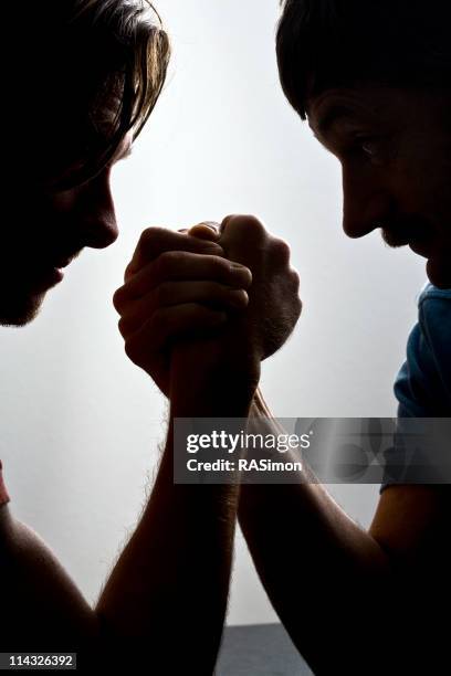 power struggle - arm wrestle stock pictures, royalty-free photos & images